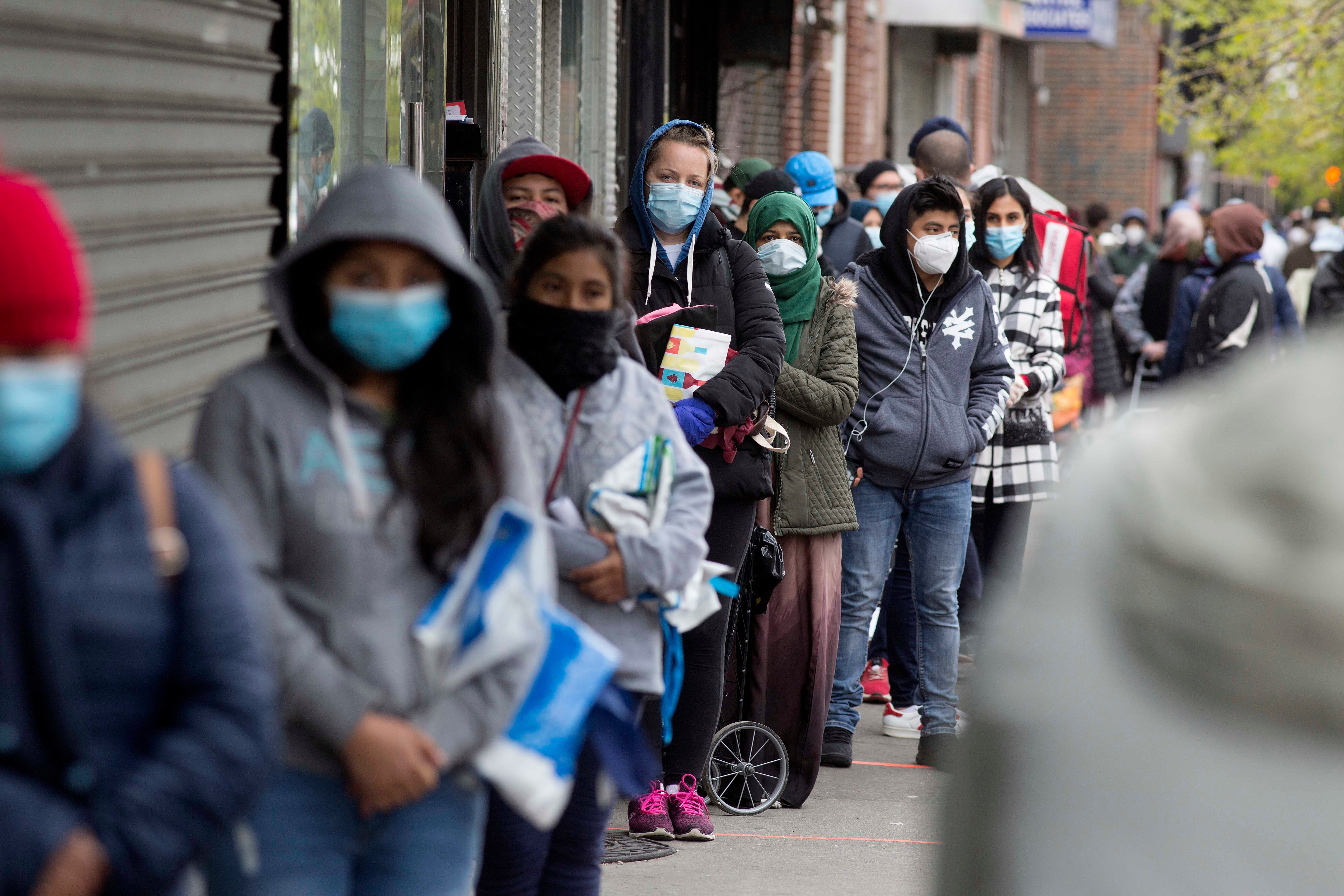 A line of people in face masks
