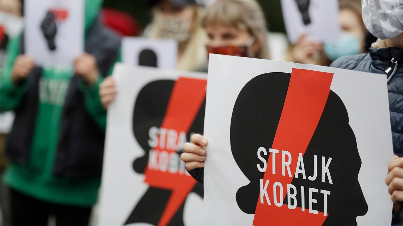 Działaczki na rzecz praw kobiet z plakatami Strajku Kobiet protestujące przed budynkiem Sejmu w Warszawie we wtorek 27 października 2020 r. przeciwko dalszym zaostrzeniom restrykcyjnej ustawy aborcyjnej.