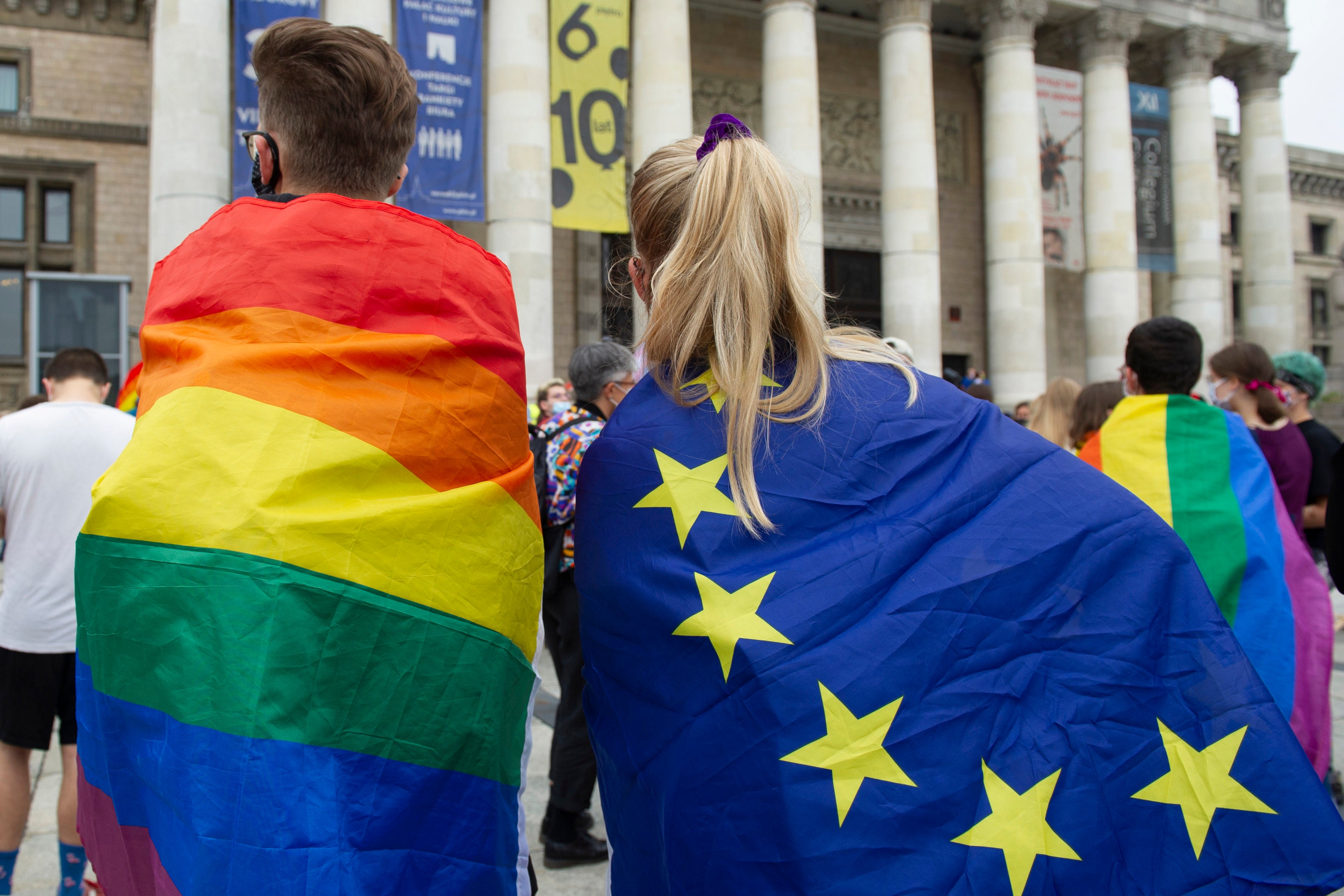 Demonstrators wrapped in LGBT and European Union flags are seen on August 30, 2020 in Warsaw, Poland. © 2020 Aleksander Kalka/NurPhoto via AP