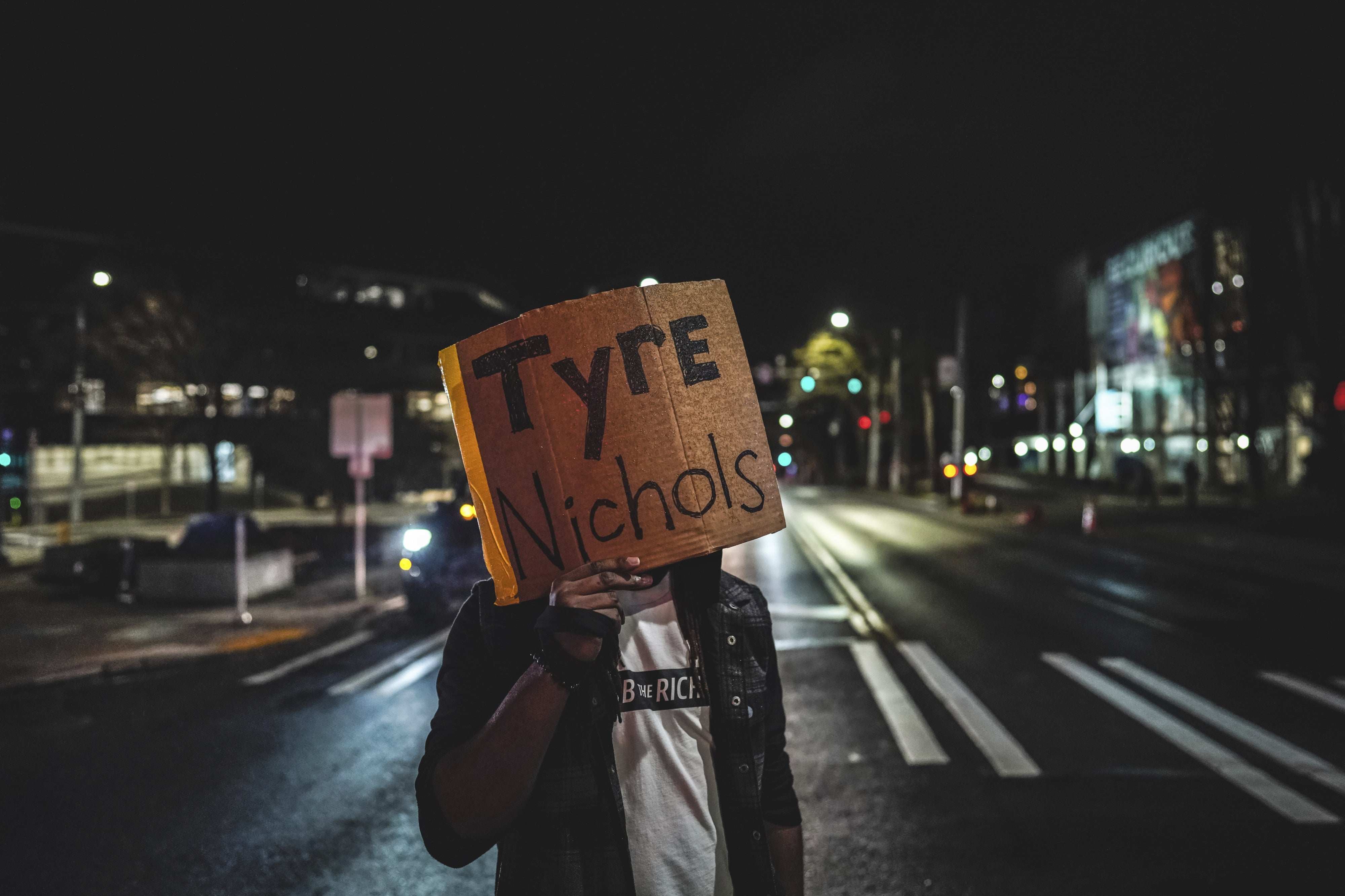 A protester holds a placard with the name Tyre Nichols, killed in January 2023 by five police officers in Memphis, Tennessee, during a demonstration in Seattle, Washington, January 27, 2023.