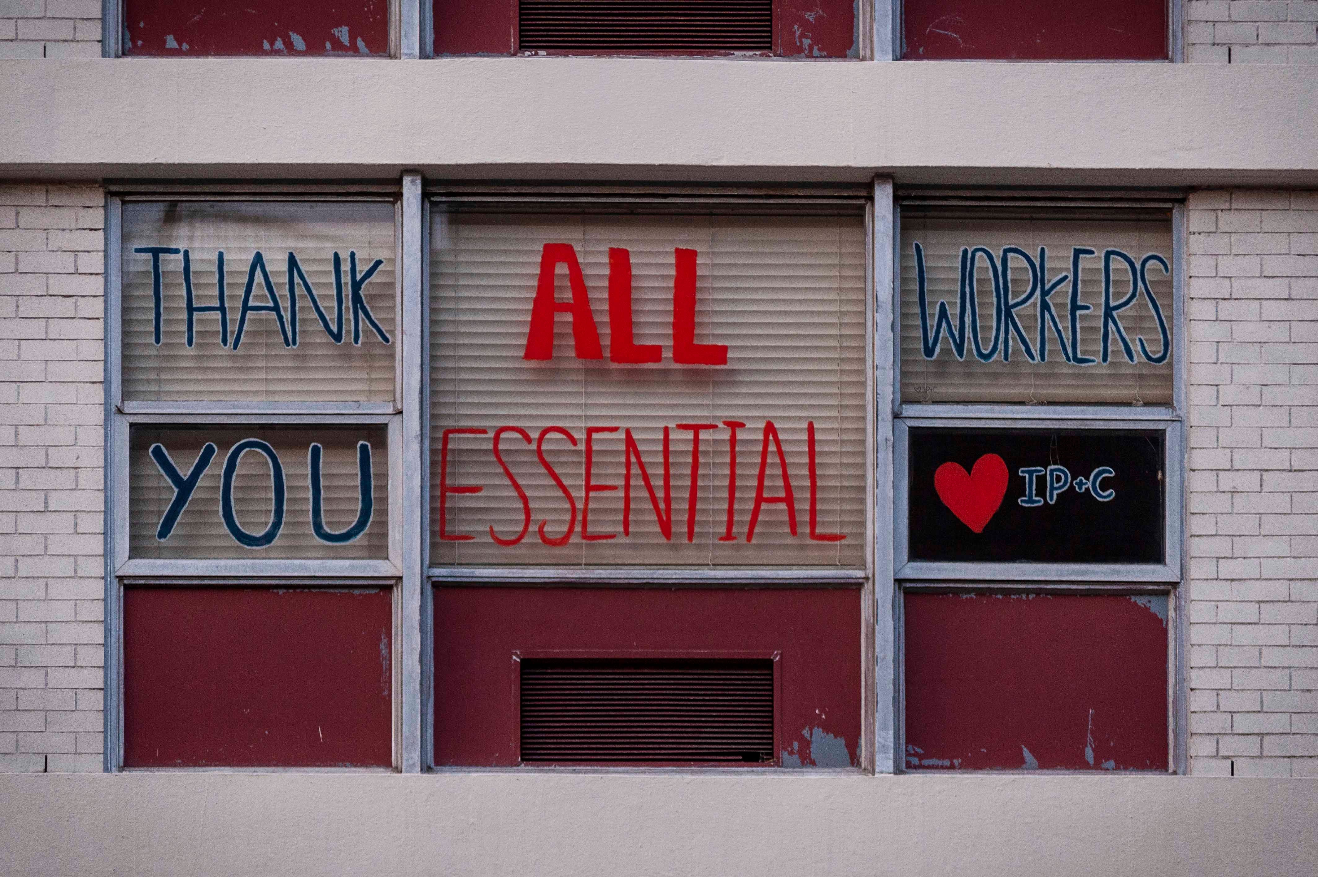 Messages of support for essential workers on a window 