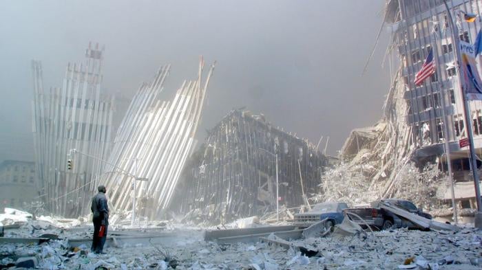 A man stands in the rubble after the collapse of the first World Trade Center Tower in New York City on September 11, 2001.