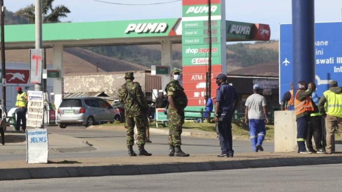 Eswatini soldiers and police officers are seen on the streets near the Oshoek Border Post between Eswatini and South Africa on July 1, 2021.