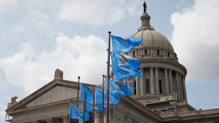 The state Capitol in Oklahoma City with state flags flying in front