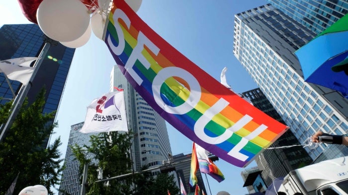 A rainbow banner is held aloft during the Seoul Queer Culture Festival in Seoul, South Korea, July 1, 2023.
