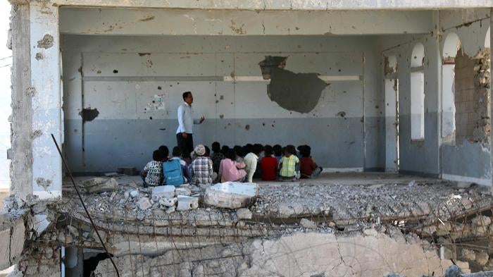 Children attending class on the first day of school, which was damaged by an airstrike during fighting between Saudi-led coalition-backed government forces and Houthi forces, Taizz, Yemen, September 3, 2019. 
