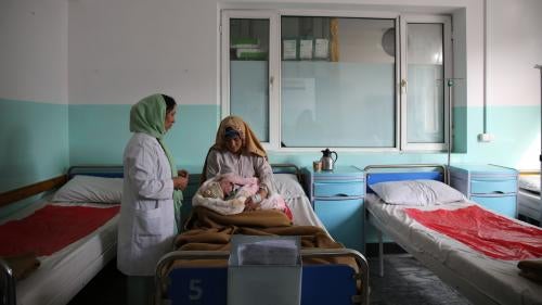 A new mother holds her hour-old baby in the maternity ward at Dasht-e-Barchi hospital in Kabul, Afghanistan, October 2020. She had travelled from neighboring Laghman province to give birth at the hospital. On May 12, 2020, unidentified gunmen attacked the hospital’s maternity ward, killing 24 people, including 16 mothers, 2 children, and a midwife. Three new mothers were killed in the delivery room. Another 20 people, including babies, were injured in the four-hour attack. Ongoing security concerns have lef