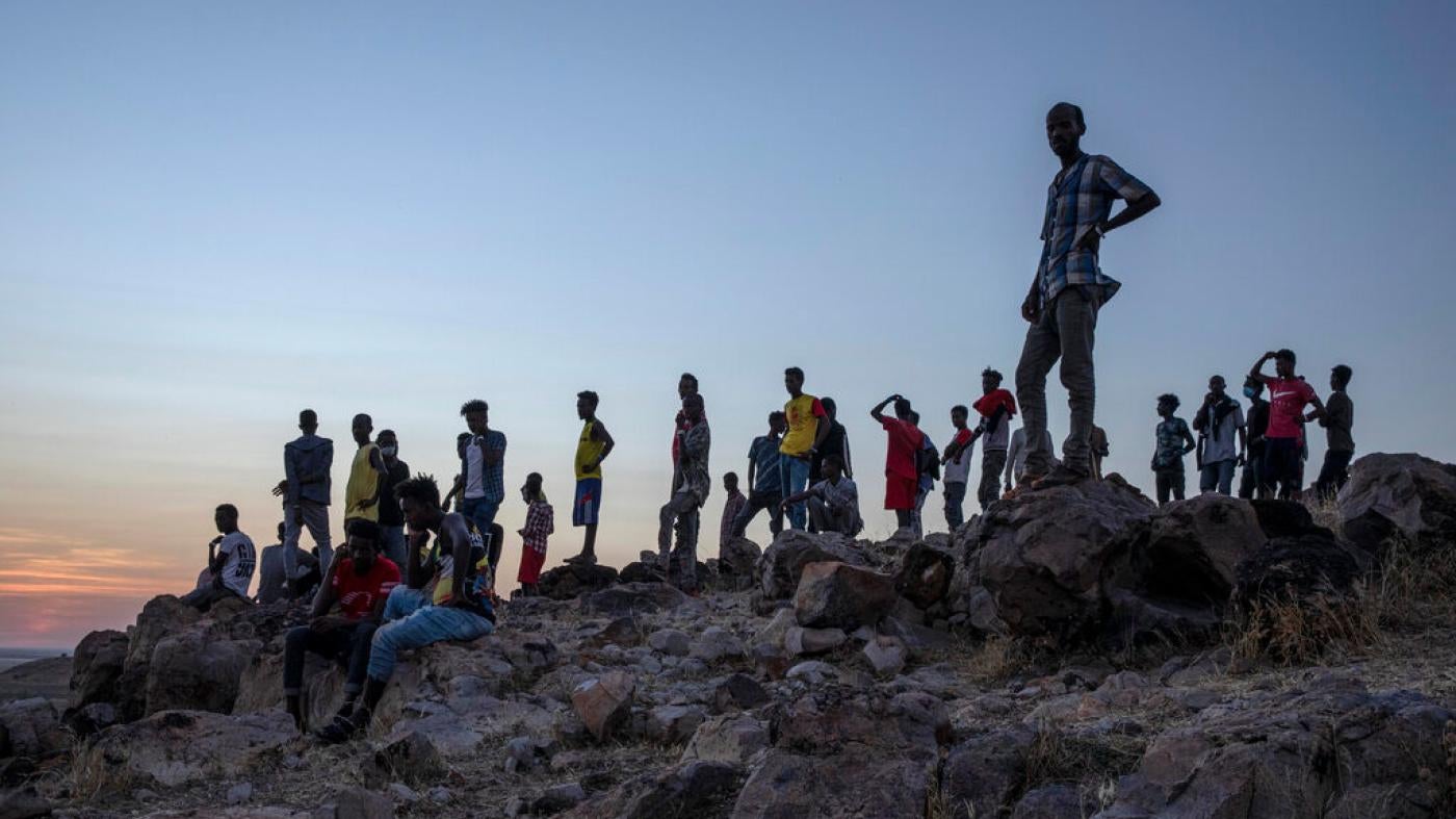 Tigrayans who fled the conflict in Ethiopia's Tigray region stand on a hilltop overlooking Umm Rakouba refugee camp in Qadarif, eastern Sudan, November 26, 2020