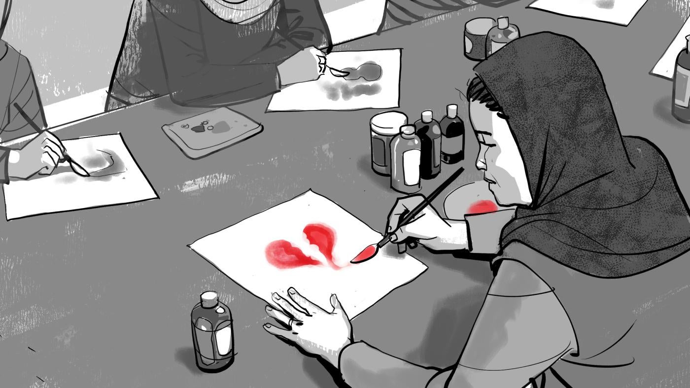 Woman paints a broken heart during art therapy session