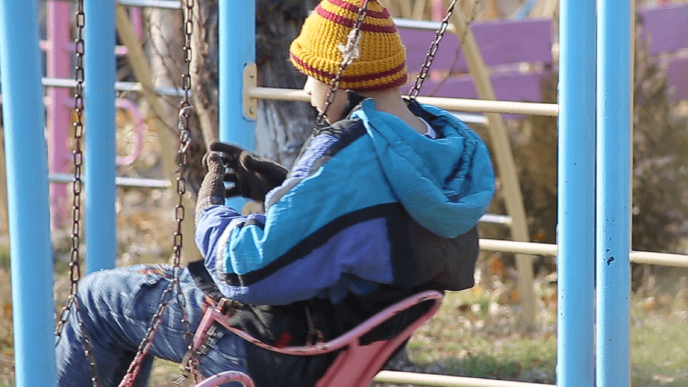 Child playing on a swing in an institution in Armenia. 