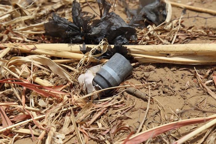 An unexploded M77 DPICM submunition on the ground. 