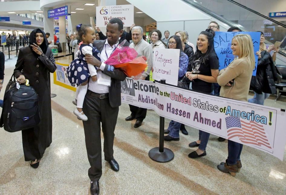 Abdisellam Hassen Ahmed, a Somali refugee who had been stuck in limbo after President Donald Trump temporarily banned refugee entries, walks with his wife Nimo Hashi, and his 2-year-old daughter, Taslim, who he met for the first time after arriving at Salt Lake City International Airport, February 10, 2017.