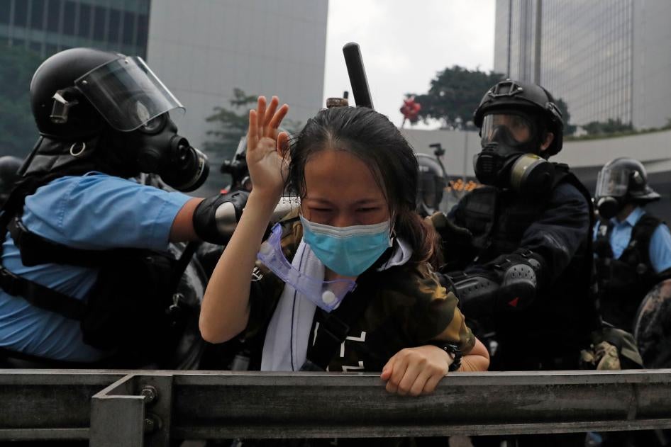 A protester is tackled by riot police during a demonstration outside the Legislative Council in Hong Kong, June 12, 2019.