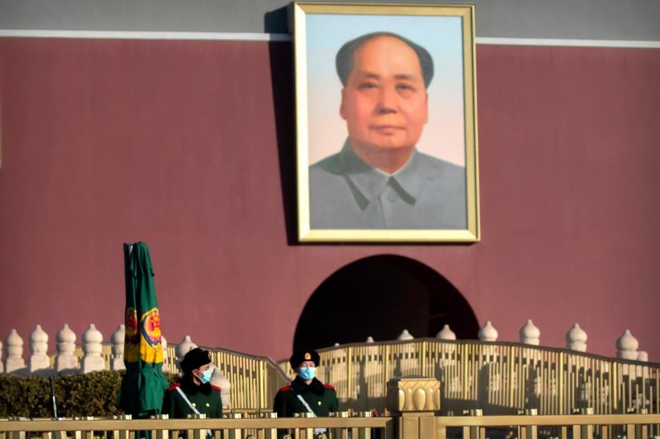 Chinese paramilitary police wearing face masks to protect against the spread of the coronavirus stand guard near the portrait of Chinese leader Mao Zedong on Tiananmen Gate near Tiananmen Square in Beijing on Saturday, January 9, 2021. 