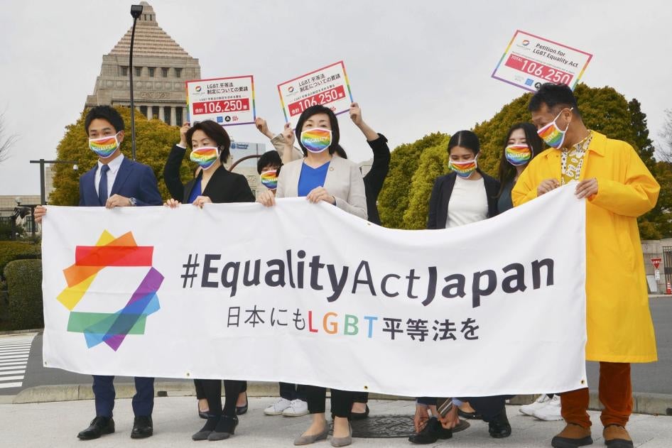 Supporters of Equality Act Japan gather in front of parliament before they submit a petition in Tokyo on March 25, 2021. 