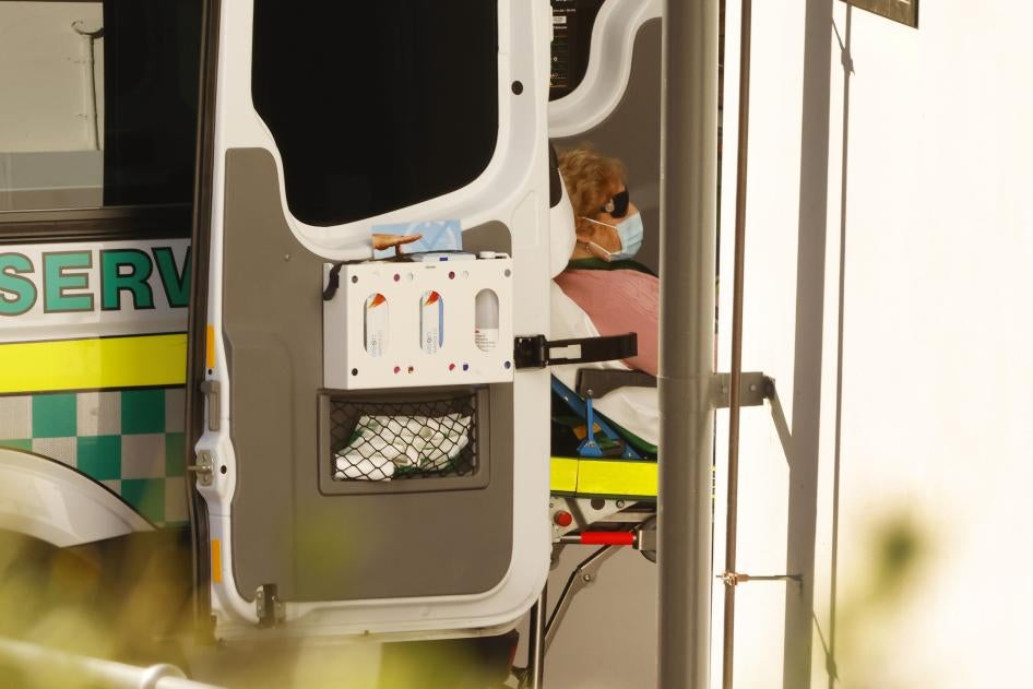 A resident of an aged care facility is loaded into an ambulance after contracting Covid-19.