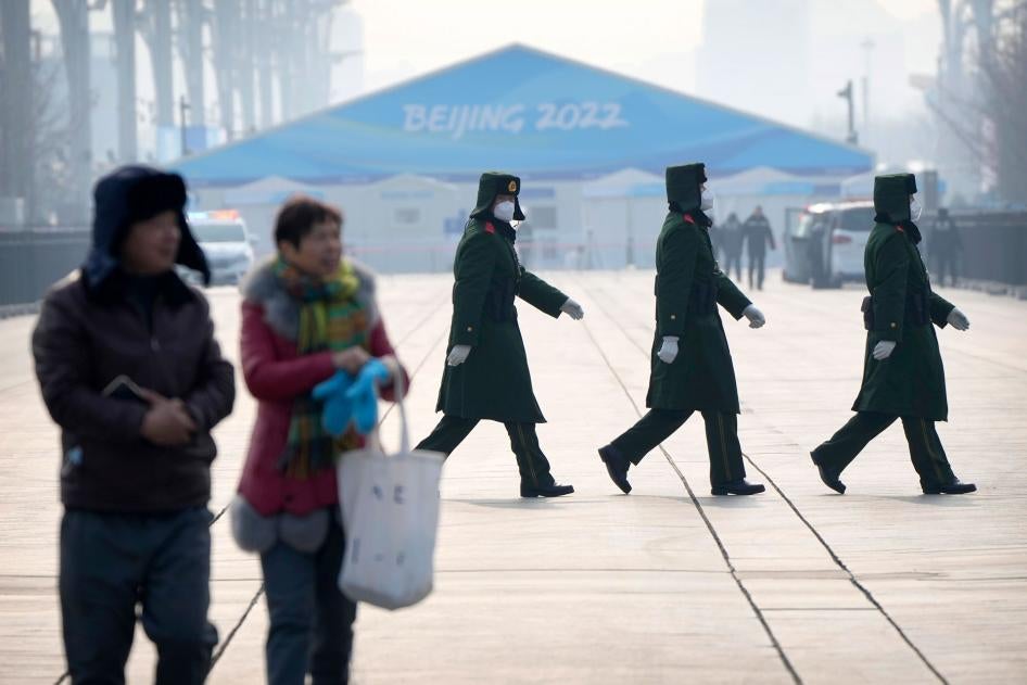 Chinese paramilitary police walk on the Olympic Green at the 2022 Winter Olympics in Beijing