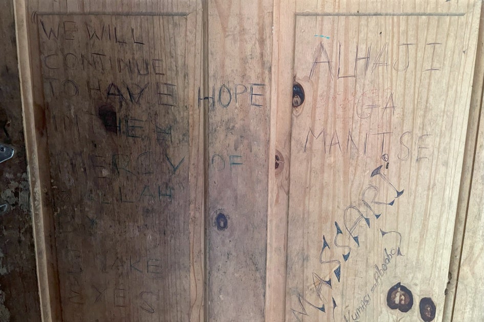 A message of hope written over one of the deteriorated doors of the migrant reception station