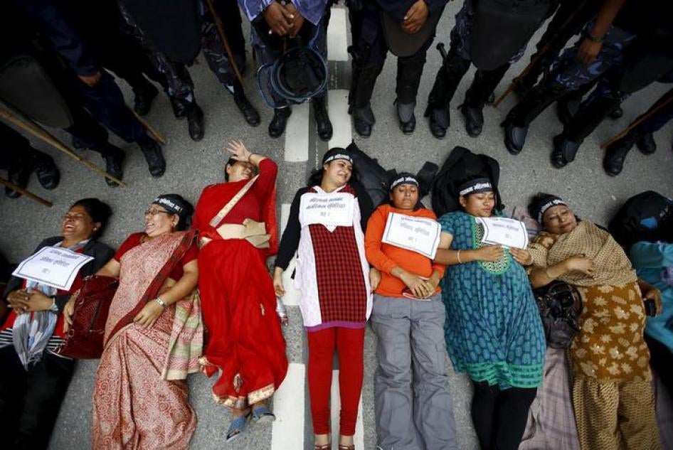 Women activists lie down on the road during a protest demanding women’s rights in the constitution in Kathmandu, Nepal, August 7, 2015.