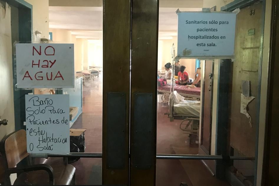 A sign that reads "There is no water" (top L) is seen at the Central University of Venezuela (UCV) hospital in Caracas, Venezuela. 