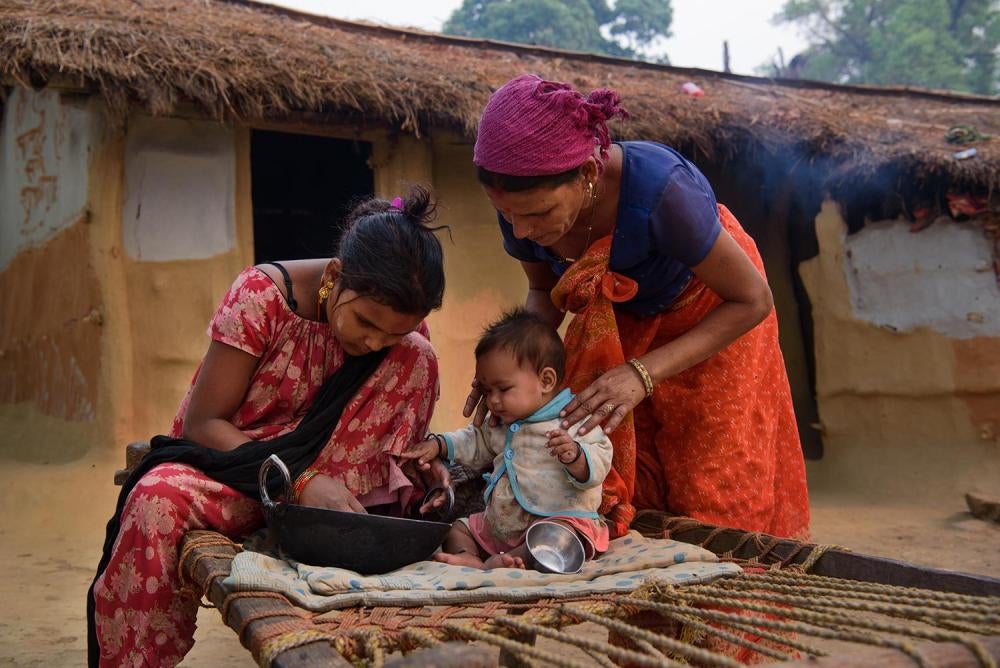 Lalita B., 17, with her mother Rajmati B. and daughter outside their home in Kailali, Nepal. Lalita had an arranged marriage at age 12 with a 37-year-old man. She became pregnant soon after marriage, and two of her newborns died. Lalita's third child surv