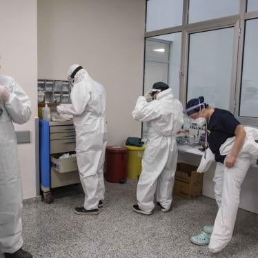 A team of doctors puts on protective suits before they meet a patient with suspected COVID-19, Istanbul May 2020. © 2020 Yasin Akgu/picture-alliance/dpa/AP Images