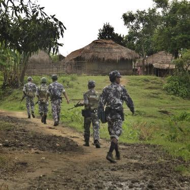 Myanmar border guard police officers walk along a path in Tin May village in northern Rakhine State, Myanmar, July 14, 2017.