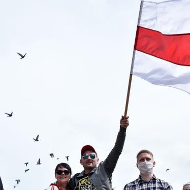 A protester waves the former national Belarus' flag in Minsk, on June 7, 2020, during a collect of signatures in support of alternative candidates ahead of Belarus presidential election on August 9, 2020.