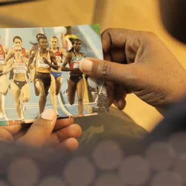 Person holding image of athletes in a race.
