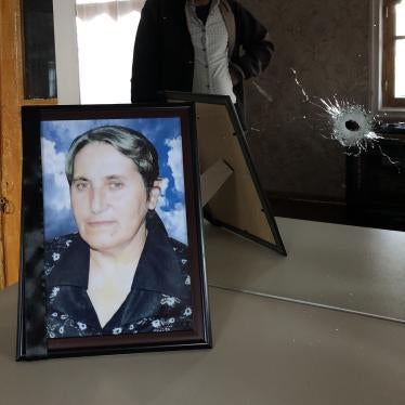Yashar Abbasov keeps a photograph of his wife, Raziya Abbasova, on a dresser with a mirror which was damaged in the attack that killed her. 