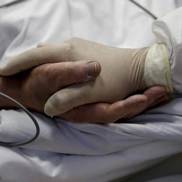A nurse holds hands with a Covid-19 patient at the intensive care unit of Casal Palocco hospital in Rome, October 20, 2020. 