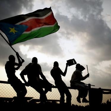 Southern Sudanese wave the national flag and cheer at South Sudan's first national soccer match after the country declared its independence, in the capital Juba on July 10, 2011