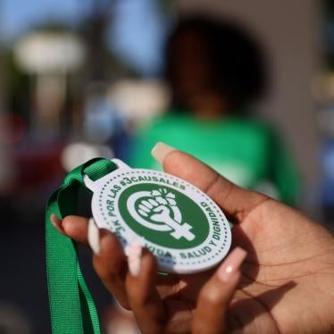 An abortion rights activist holds a plastic medallion reading "For the #3Causales (#3LegalGrounds), Life, Health and Dignity" during a protest to urge parliament to approve a proposed reform to the penal code that could end the total ban on abortion, in Santo Domingo, Dominican Republic March 18, 2021. 