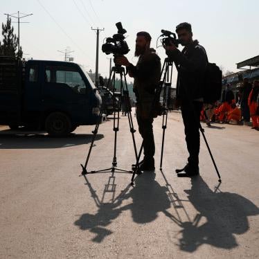 Afghan journalists film at the site of a bombing attack in Kabul, Afghanistan, Tuesday, Feb. 9, 2021. 