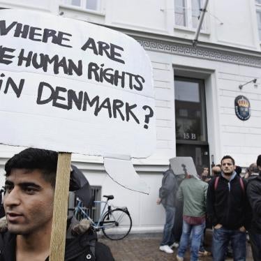 Syrian refugees hold banners outside the Swedish Embassy in Copenhagen, Denmark, protesting Denmark's asylum policies towards those who fled Syria's civil war, September 26, 2012.