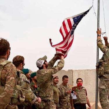 A US flag is lowered as American and Afghan soldiers attend a handover ceremony from the US Army to the Afghan National Army, at Camp Anthonic, in Helmand province, southern Afghanistan on May 2, 2021.