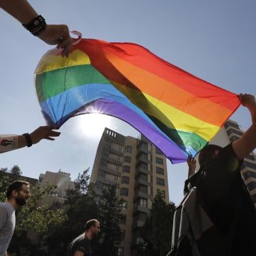 LGBT activists in Beirut, Lebanon shout slogans and hold up a rainbow flag as they march to demand equal rights in a country gripped by economic and financial crisis, June 27, 2020.