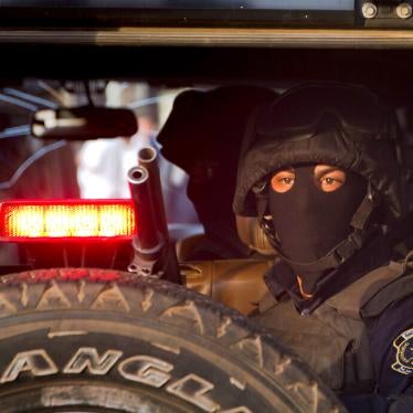 A masked Egyptian policeman watches Tahrir Square in Cairo, Egypt.