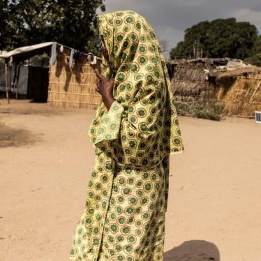 A woman walks through the Internally Displaced Person camp "25 de junho," in Metuge, Mozambique on May 20, 2021. 