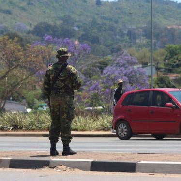 A soldier stands in the road in Manzini on October 20, 2021 where at least 80 people were injured in Eswatini.