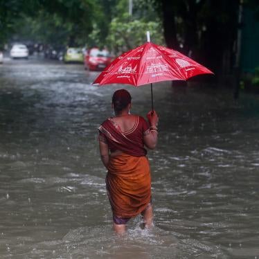 A woman walks through a flooded street during heavy rains in Mumbai, India on June 12, 2021.