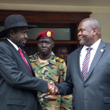 South Sudan's president Salva Kiir, left, and vice-president Riek Machar, right, shake hands