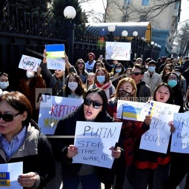Demonstrators hold anti-war posters during an action against Russia’s attack on Ukraine near the Russian Embassy in Bishkek, Kyrgyzstan, February 28, 2022.