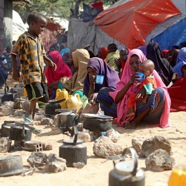 Somali families, displaced after fleeing the Lower Shabelle region amid an uptick in US airstrikes, wait at an Internally Displaced Person camp near Mogadishu, Somalia, March 12, 2020.
