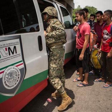 A Mexican Marine orders a group of migrants from Bangladesh, India and Pakistan off a bus at an immigration checkpoint