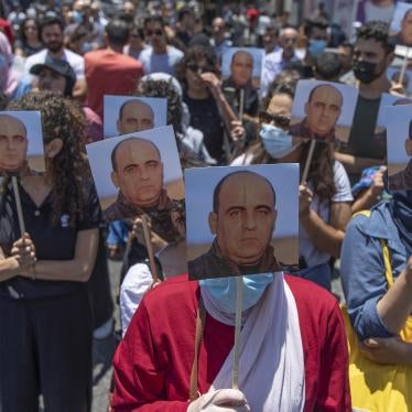 Demonstrators carry pictures of activist Nizar Banat during a protest in the West Bank city of Ramallah on the same day he was beaten to death in Palestinian Authority custody, Thursday, June 24, 2021.