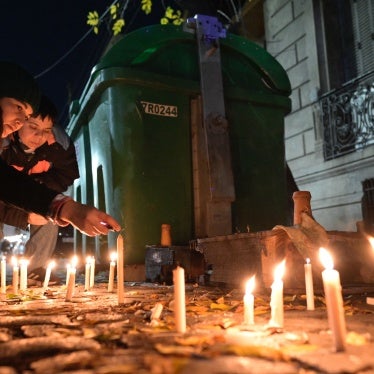 People light candles during a vigil on May 8, 2024, in front of the house where three lesbian women were killed following an attack in Buenos Aires.