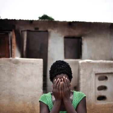 A woman hides her face after recounting how pro-Ouattara forces killed two of her children and her brother during the post-election violence in Duékoué, western Côte d’Ivoire.