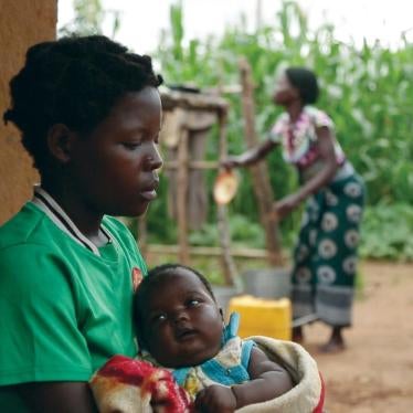 A 14-year-old girl holds her baby at her sister’s home in a village in Kanduku, in Malawi’s Mwanza district. She married in September 2013, but her husband chased her away. Her 15-year-old sister, in the background, married when she was 12.