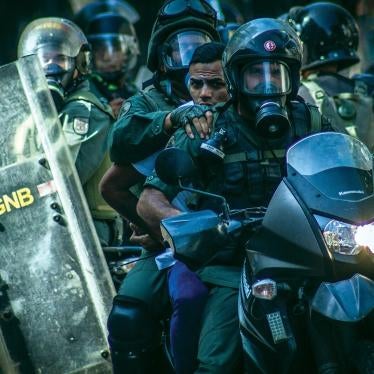 Members of the National Bolivarian Police detain a demonstrator at anti-government protests in Caracas, Venezuela, March 22, 2014.